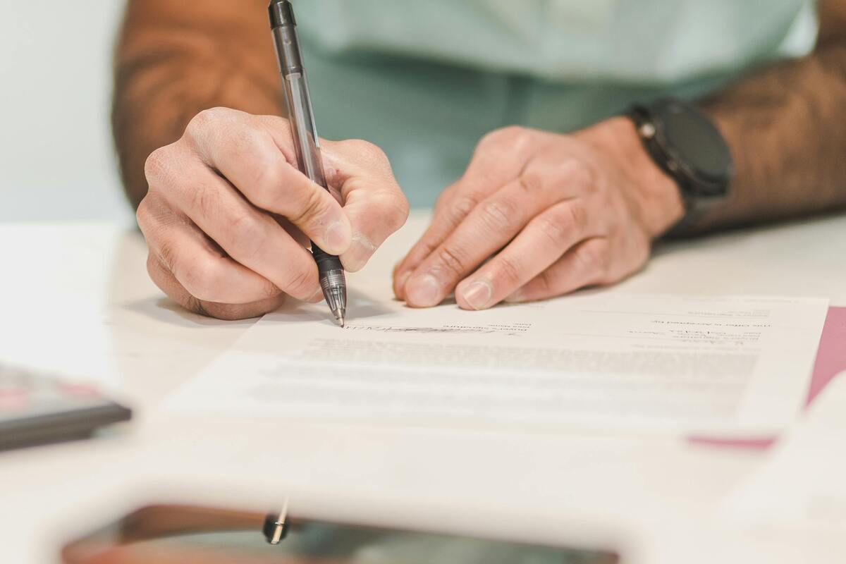 Person signing paper